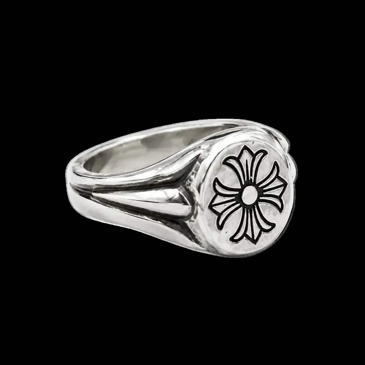 A silver-toned signet-style ring with a textured band and a round face featuring an engraved black floral or cross-like motif, shown on a clean white background.